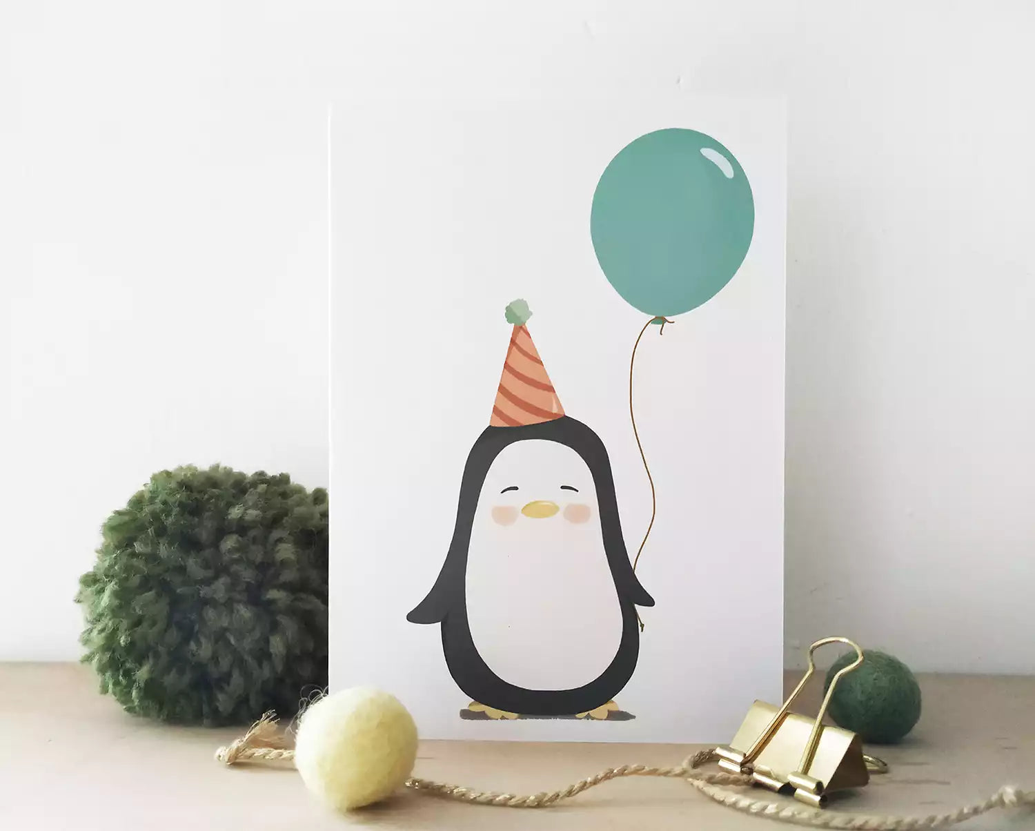 birthday card with a penguin holding a balloon. personalised with name and age