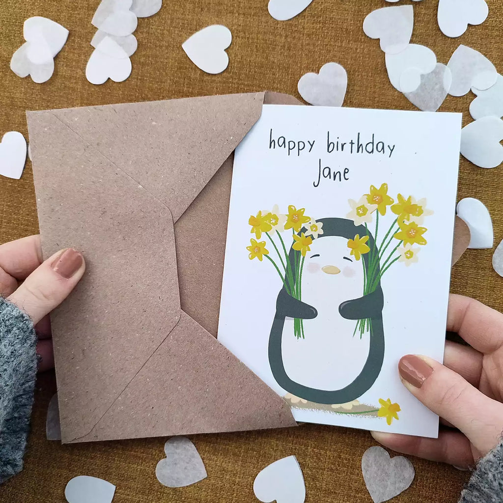 personalised birthday card featuring a penguin holding daffodils