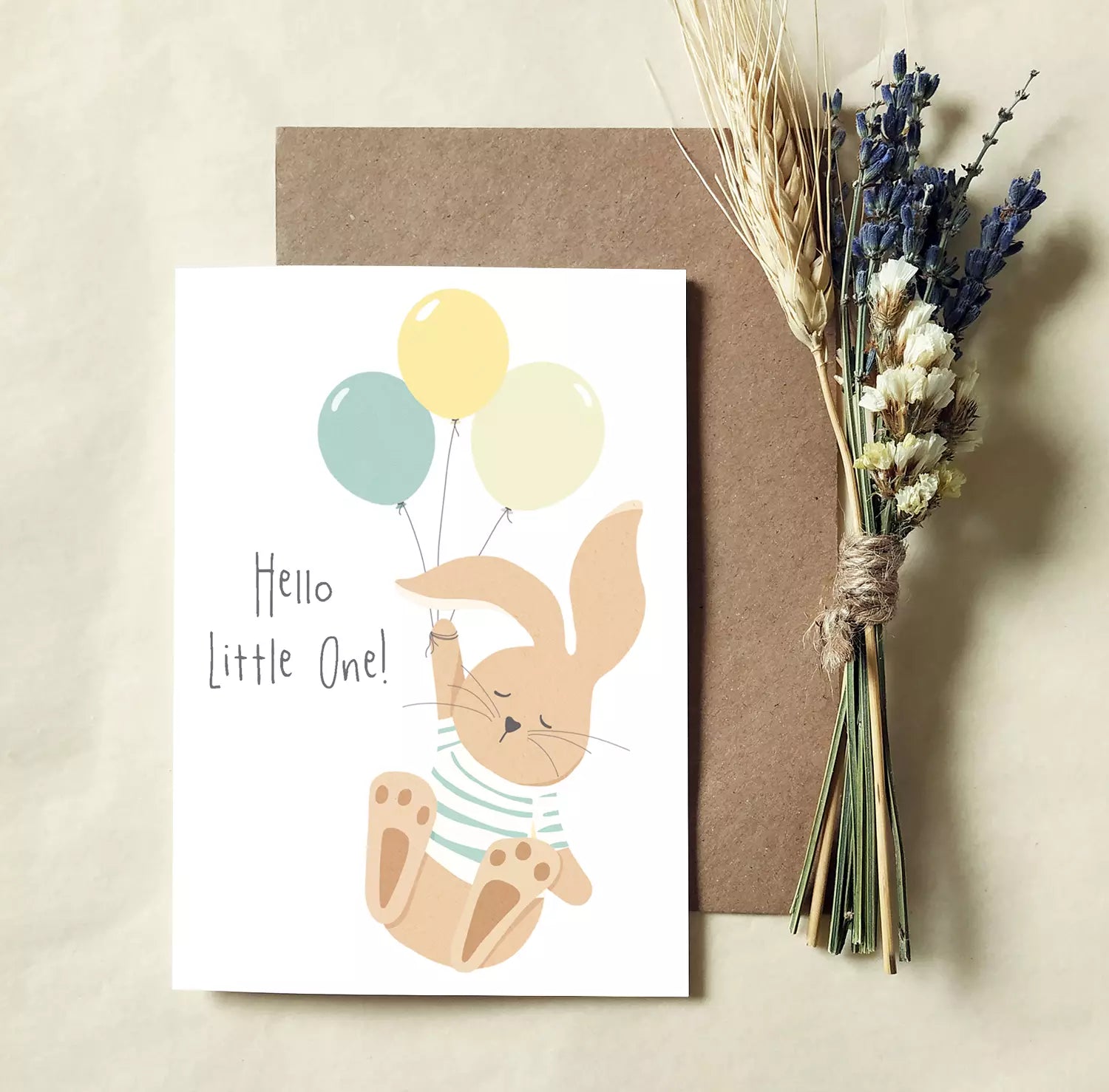 new baby card featuring a bunny holding balloons. text reads 'hello little one!'