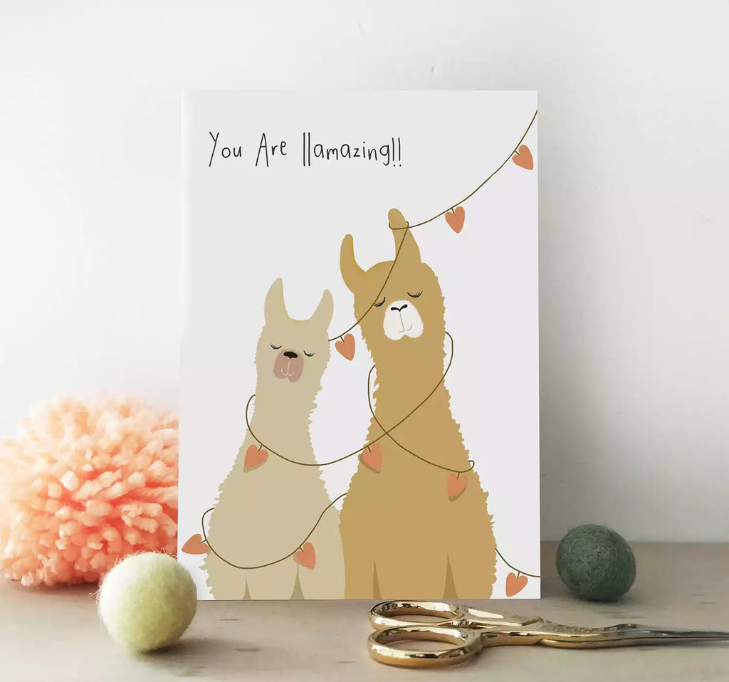 card featuring two llamas and heart bunting, pun 'you are llamazing.'