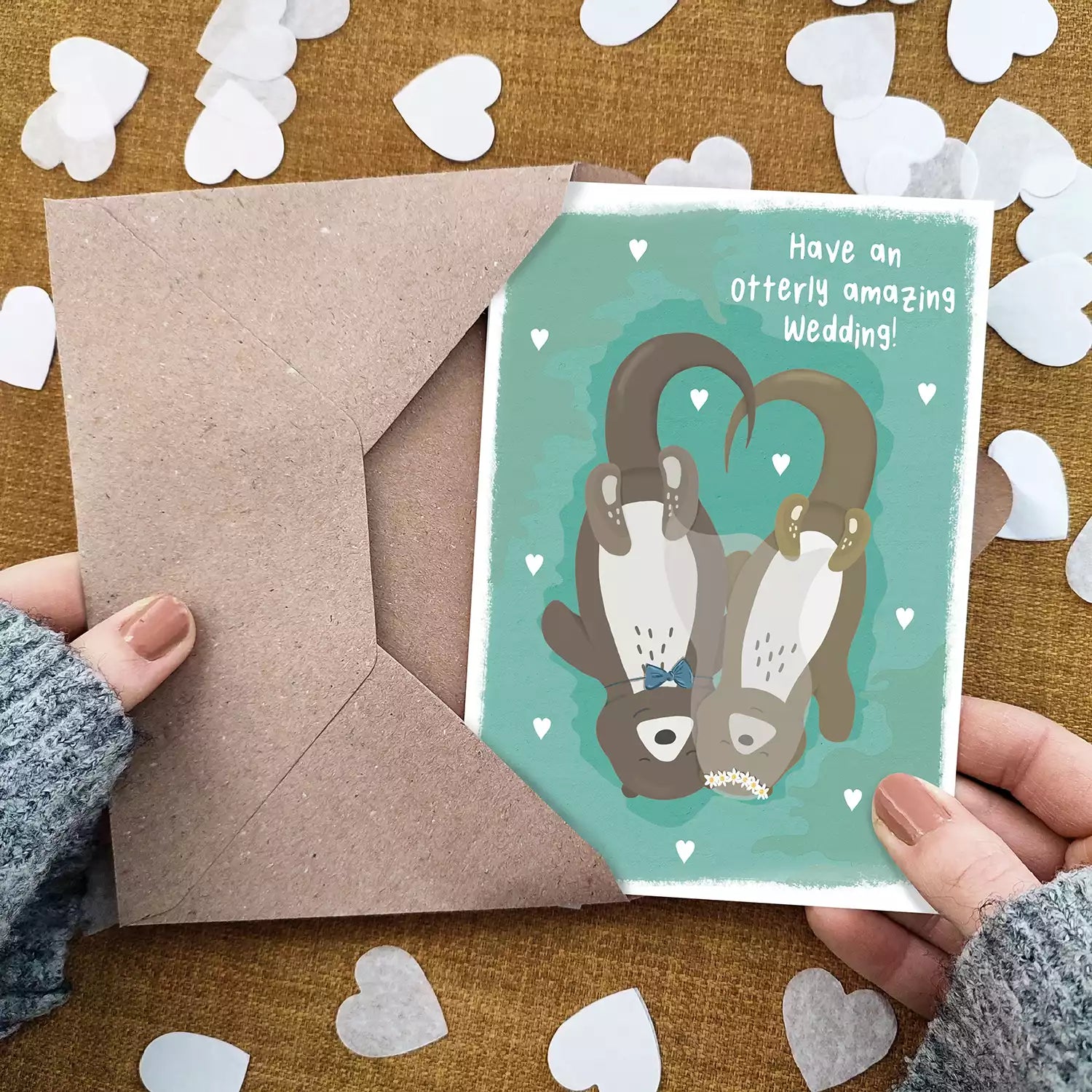 Otter pun couple card with text 'Have an otterly amazing wedding! Personalised with couple's names.