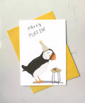 birthday card with a puffin looking at a caterpillar cake. Caption 'party puffin'