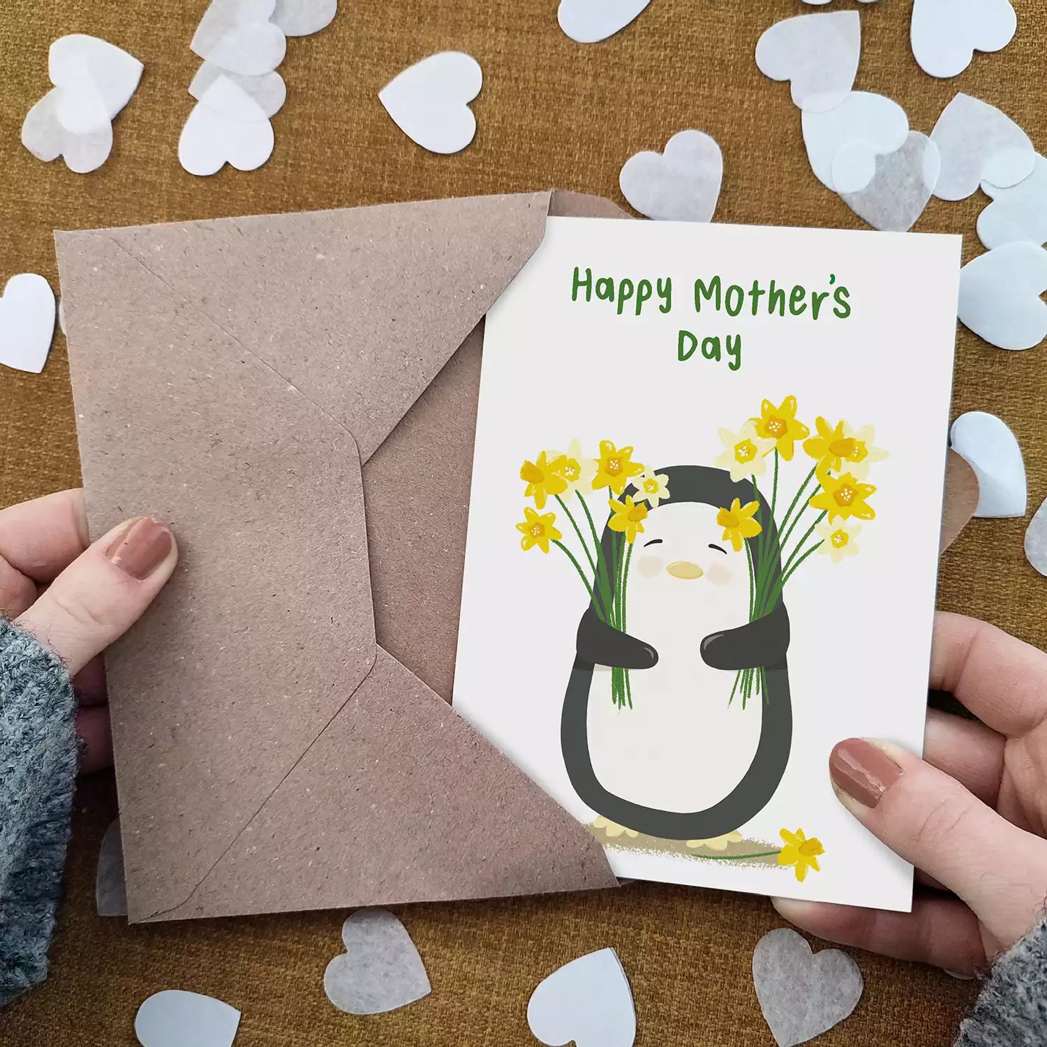 penguin holding daffodils and text 'happy mother's day'