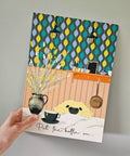 Illustrated kitchen print with a dog, coffee cup, and decorative elements on a patterned background