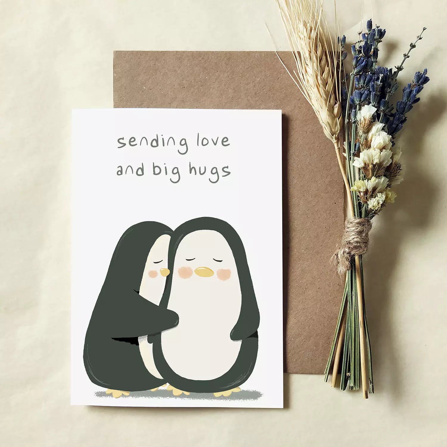 card with two penguins hugging and text 'sensing love and big hugs'