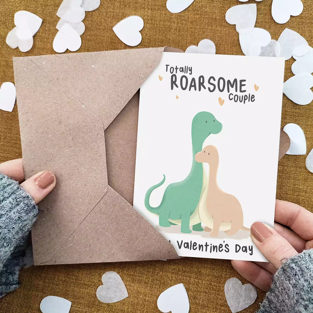 valentines day card with two dinosaurs and pun 'totally roarsome couple'