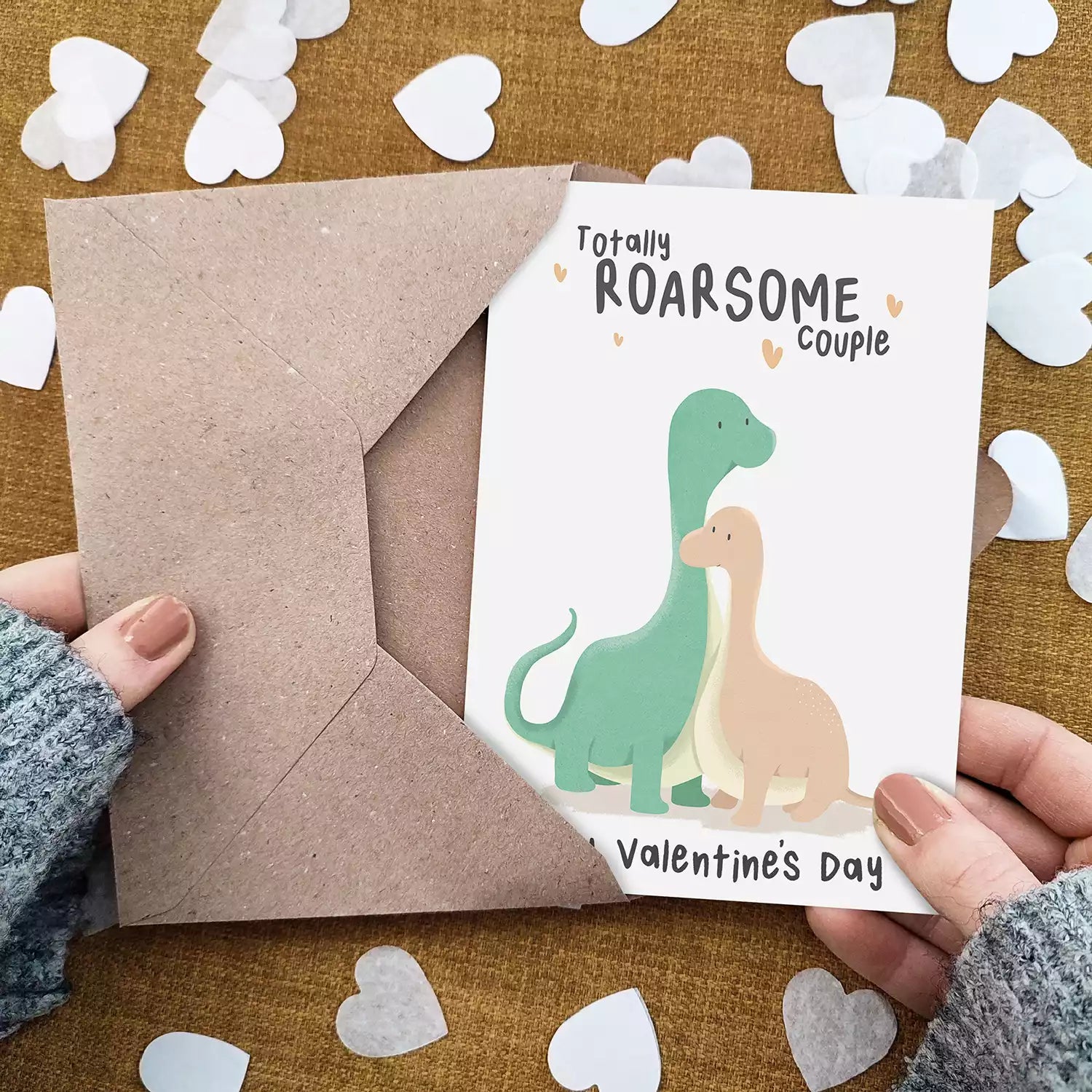 valentines day card with two dinosaurs and pun 'totally roarsome couple'